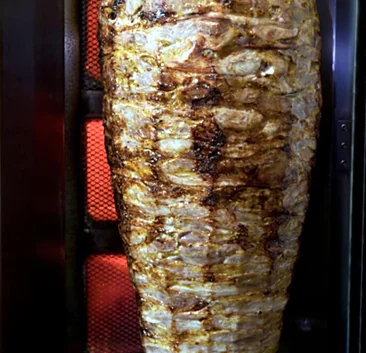 Chicken doner spit roasting on the vertical broiler